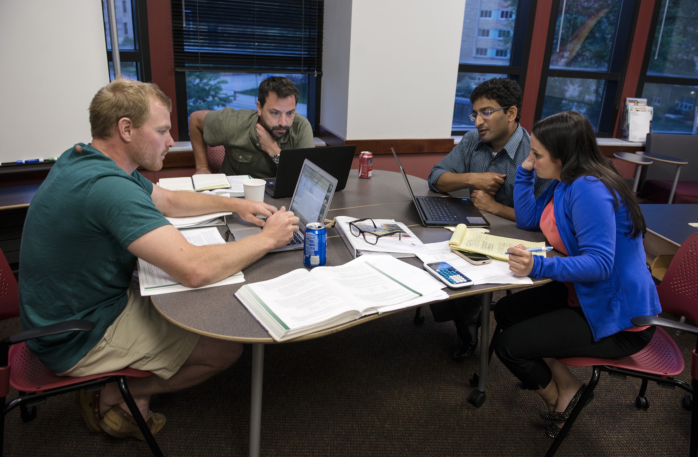 Evening MBA students (L to R) Ryan Wagner, Keith Boucher, Aroon Viswanathan and Katie Kapler breaks into their group to work on a problem before the start of the second-half of Adjunct Professor Davey Scoon Accountant class on Monday, July 6, 2015 in Grainger Hall.