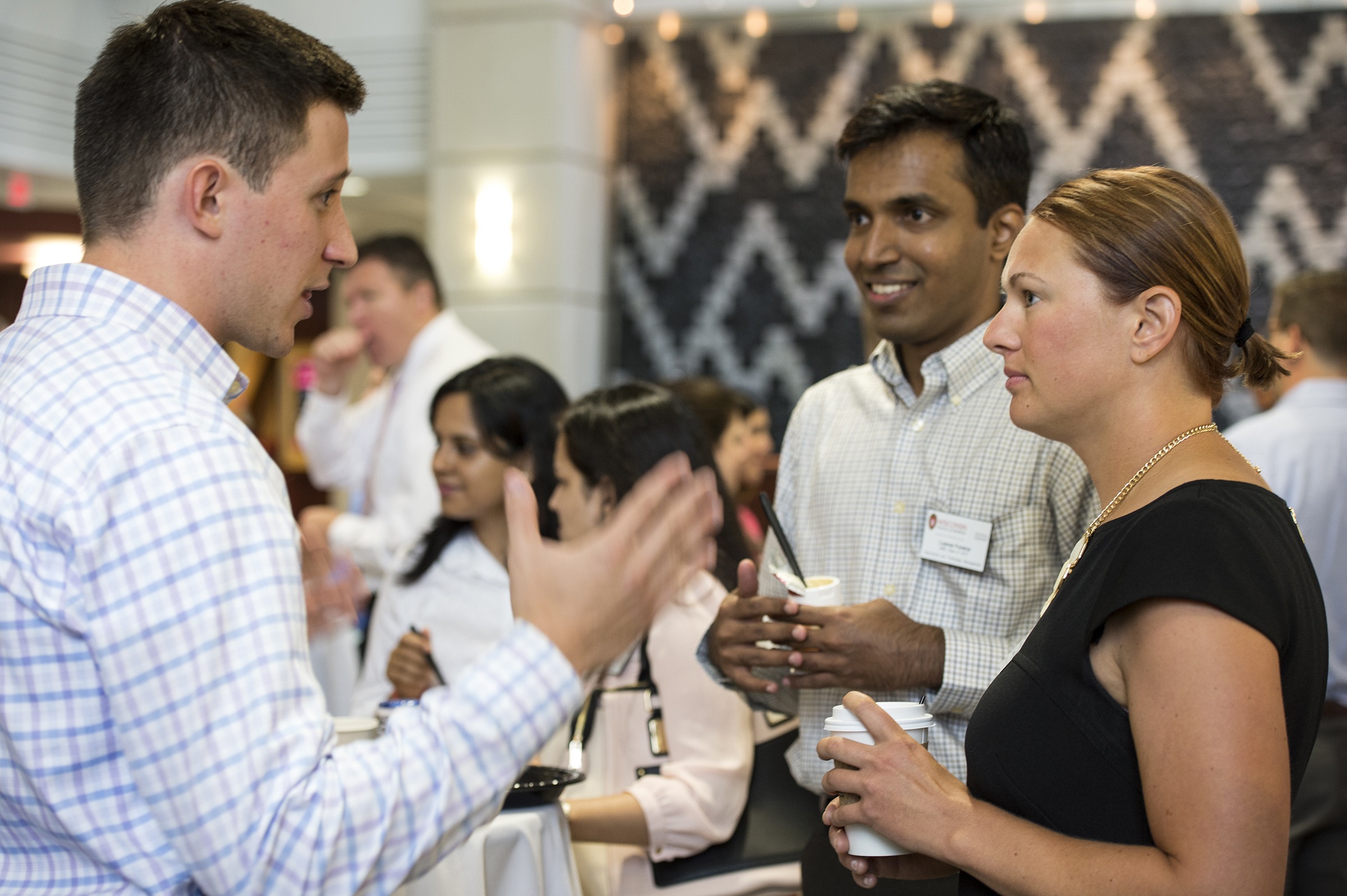 MBA student talks with incoming MBA students during the Orientation and Continental Welcome Breakfast
