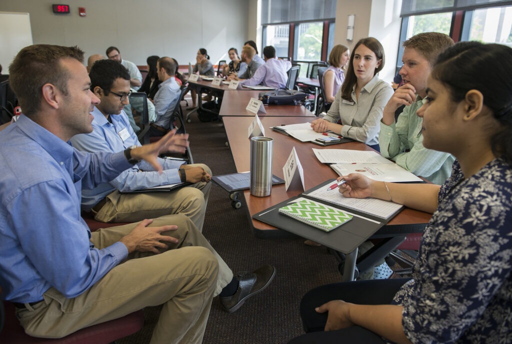 a group of MBA students gathered around a table