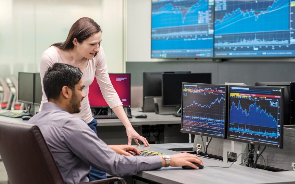 two students work over screens in learning commons