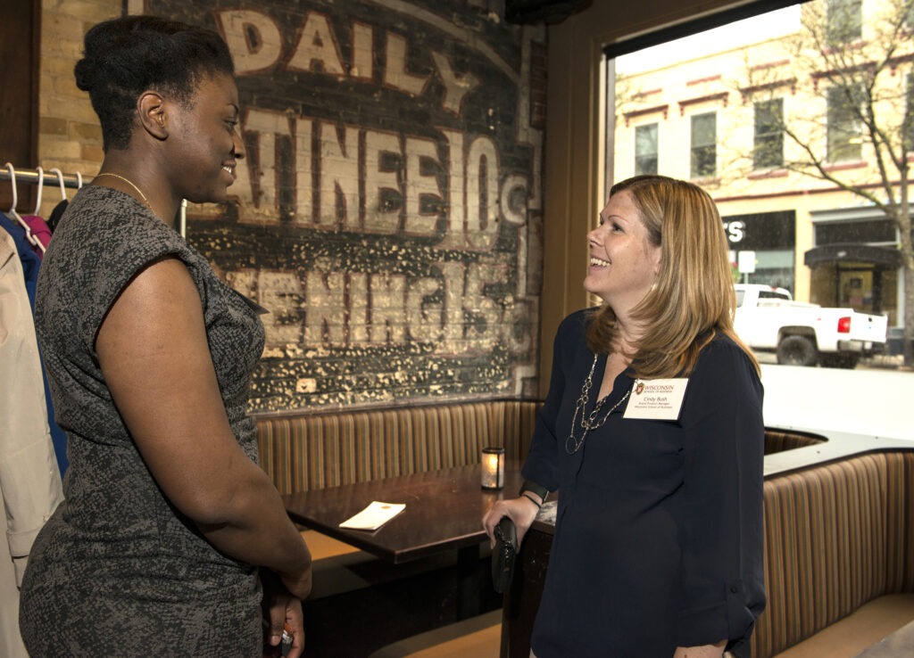 Cindy Bush and Camille Clark talk to each other at the Wisconsin Women in Business Networking Social