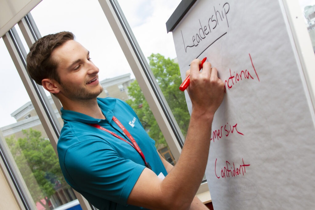 person writing on board