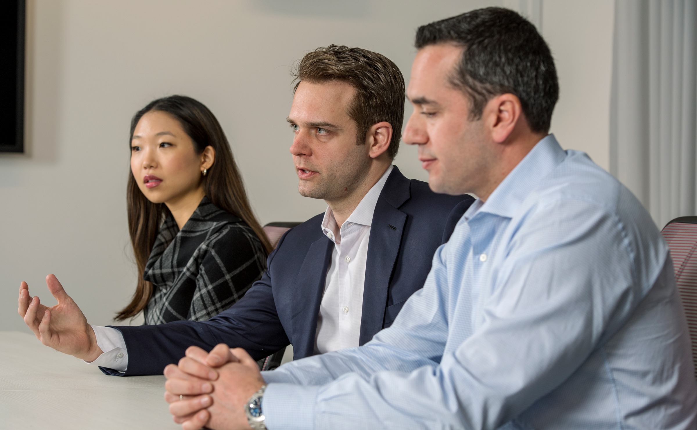 Three MBA students speaking at a panel discussion