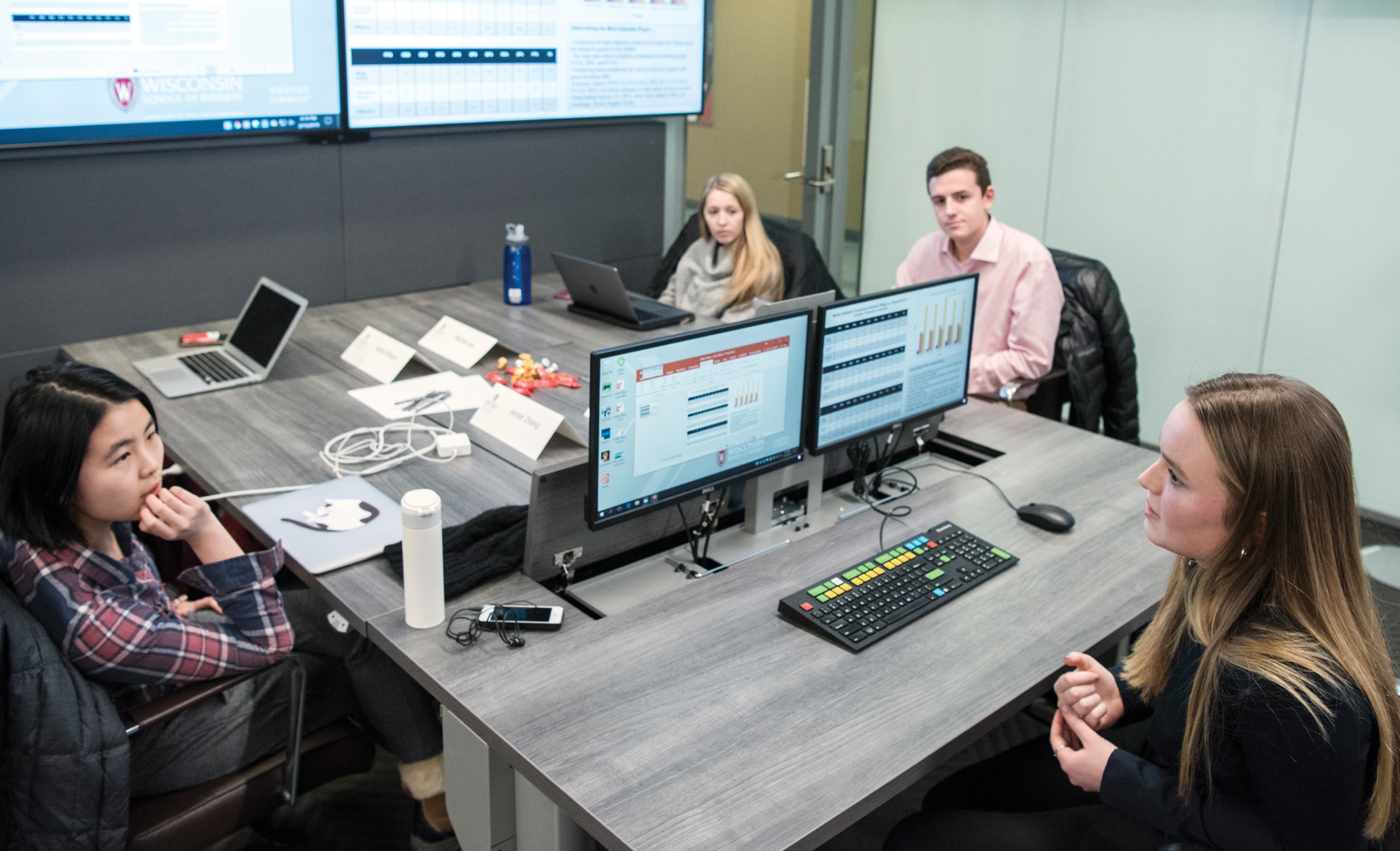 Four people sitting at a table during a workshop