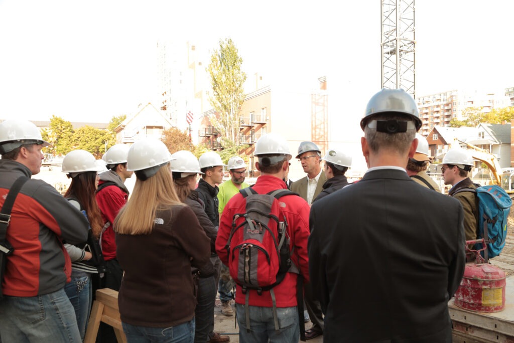Students in hard hats at construction site