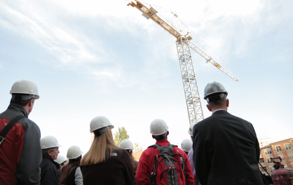 students in hard hats at construction site