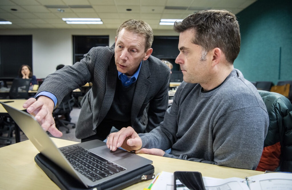 Students working with they professor