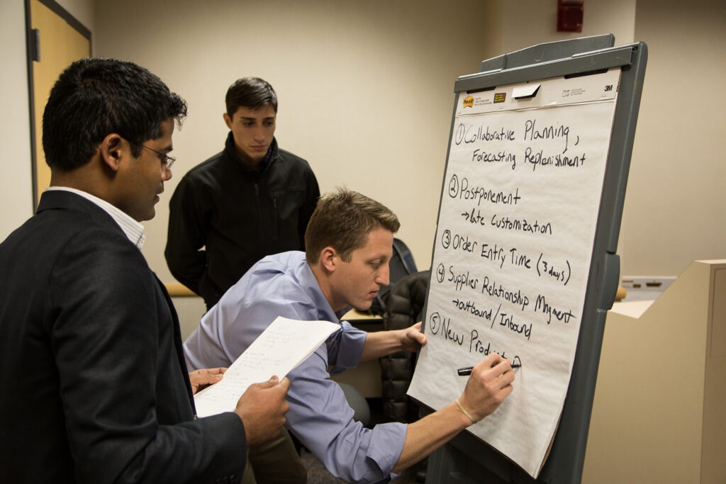 Students writing on board