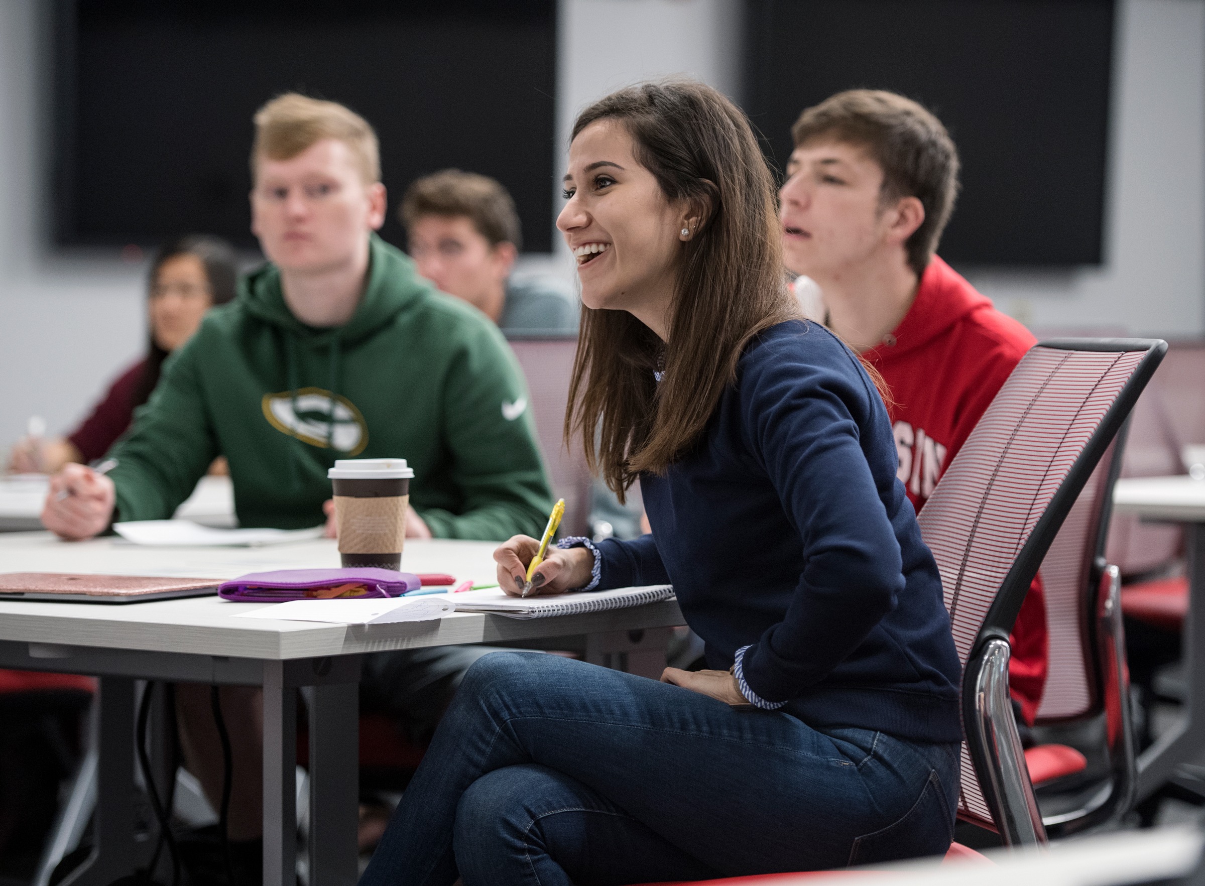 Students sitting at a table taking notes