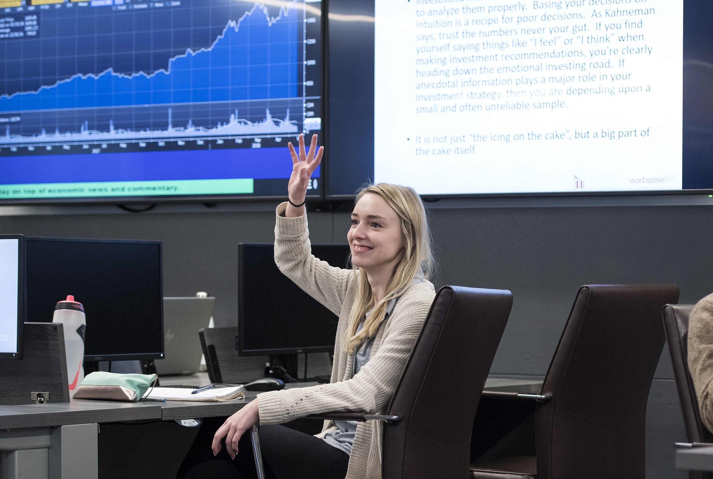 student raises hand in learning commons classroom