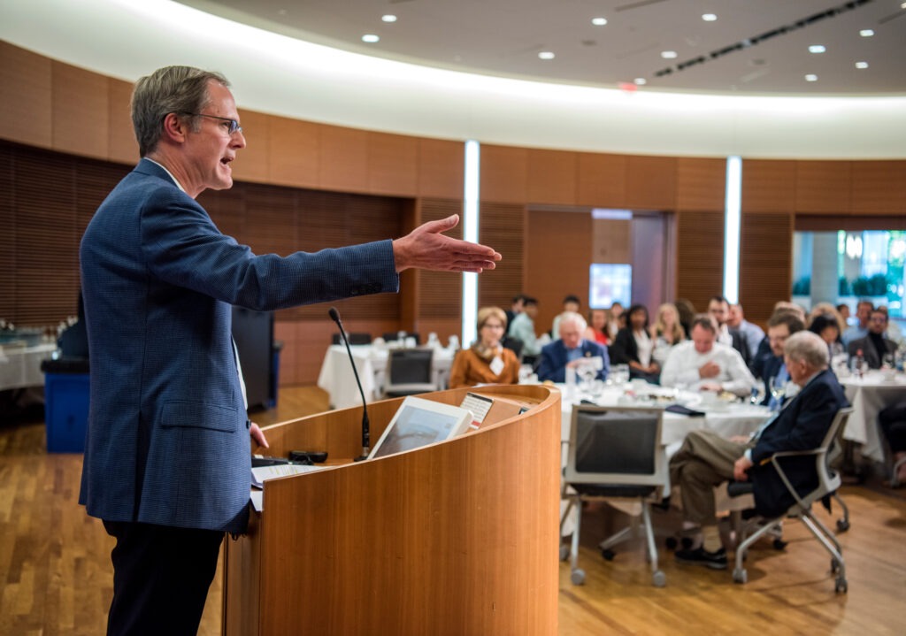 A man giving a speech at Morgridge Entrepreneurial Bootcamp dinner