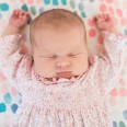 photo of baby Sloan with eyes closed and arms stretched up