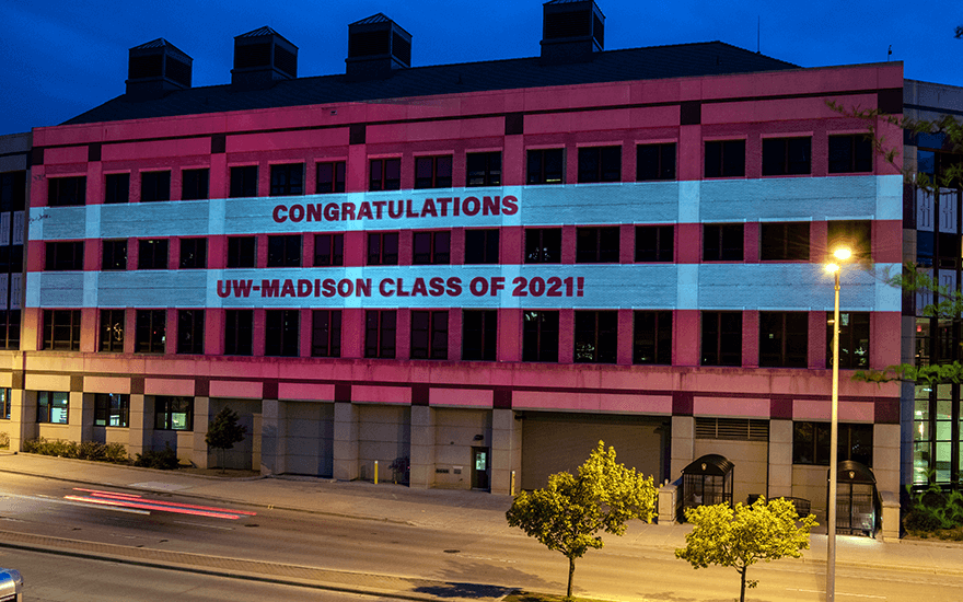 Grainger Hall with "Congratulations UW-Madison Class of 2021!" on the side of the building