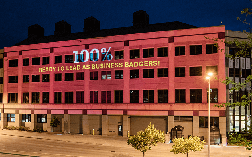 Grainger Hall with "100% Ready to Lead as Business Badgers!" on the side of the building