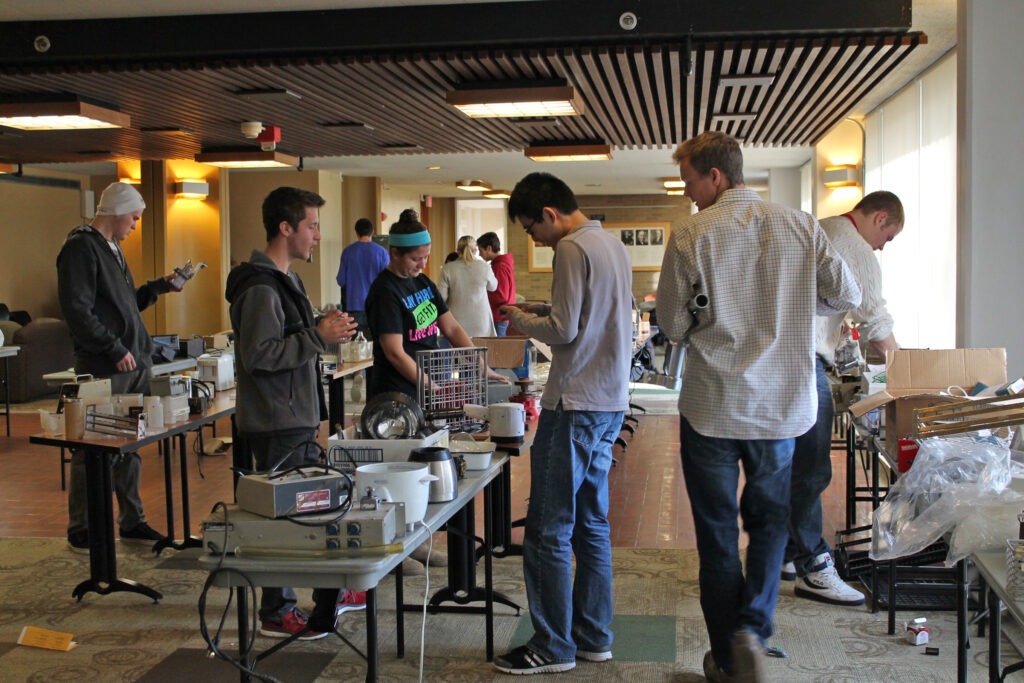 Students looking at objects at the 100 Hour Challenge