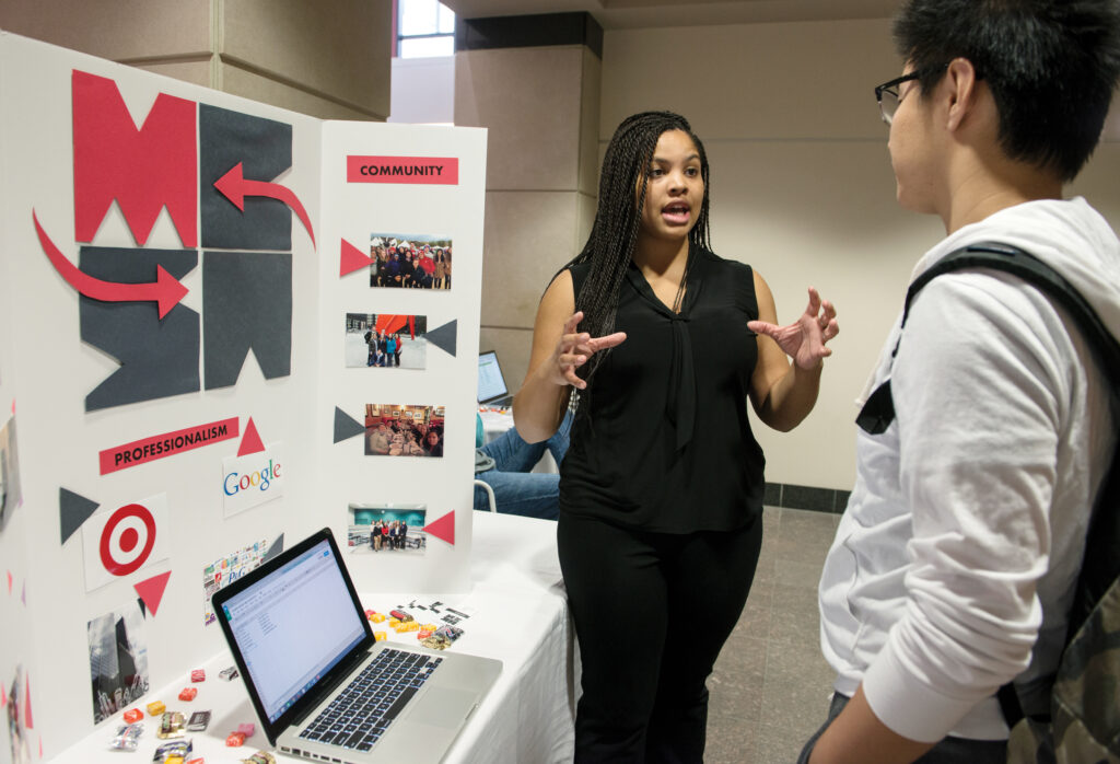 A woman giving a presentation to students