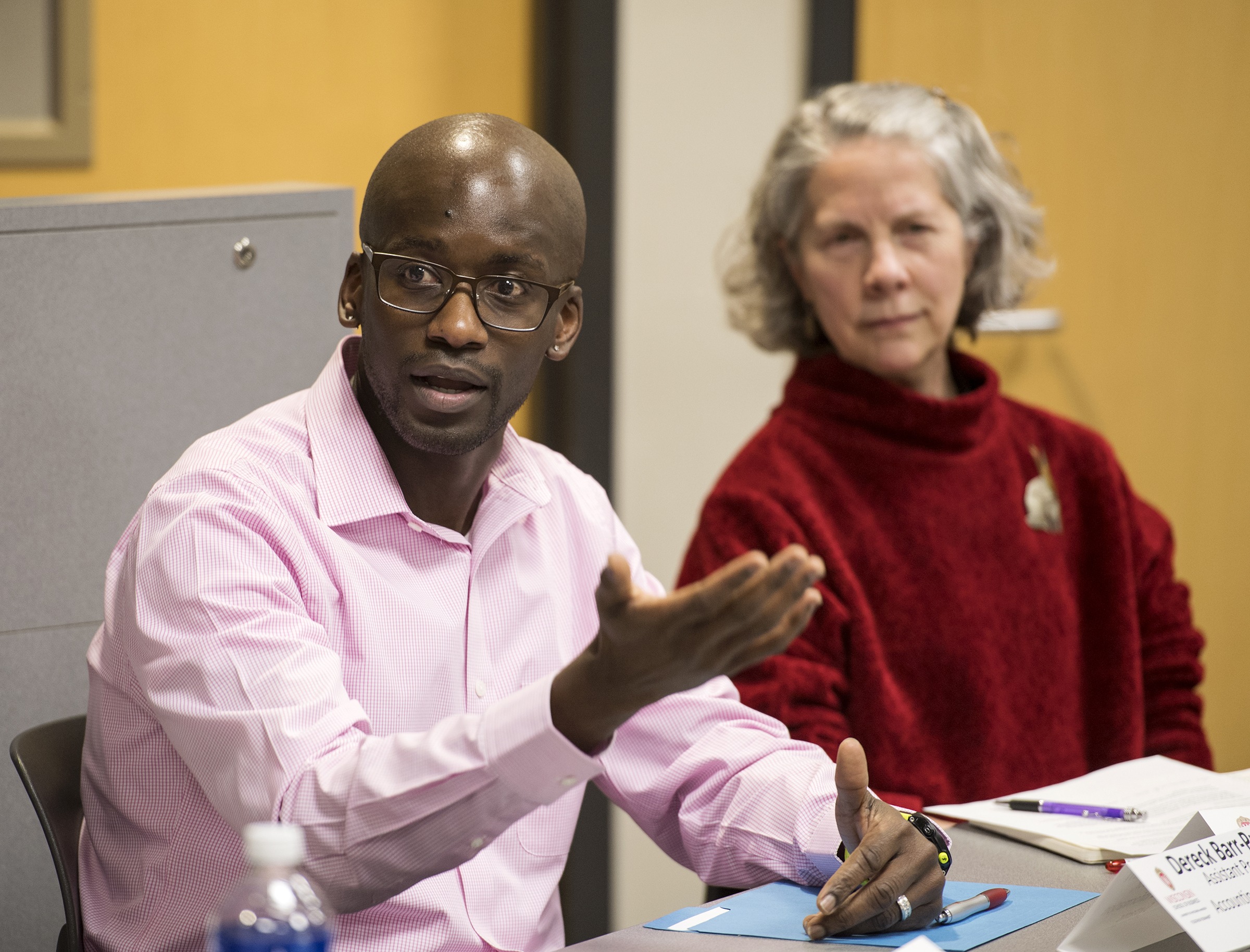 Two faculty members speaking during a panel session.