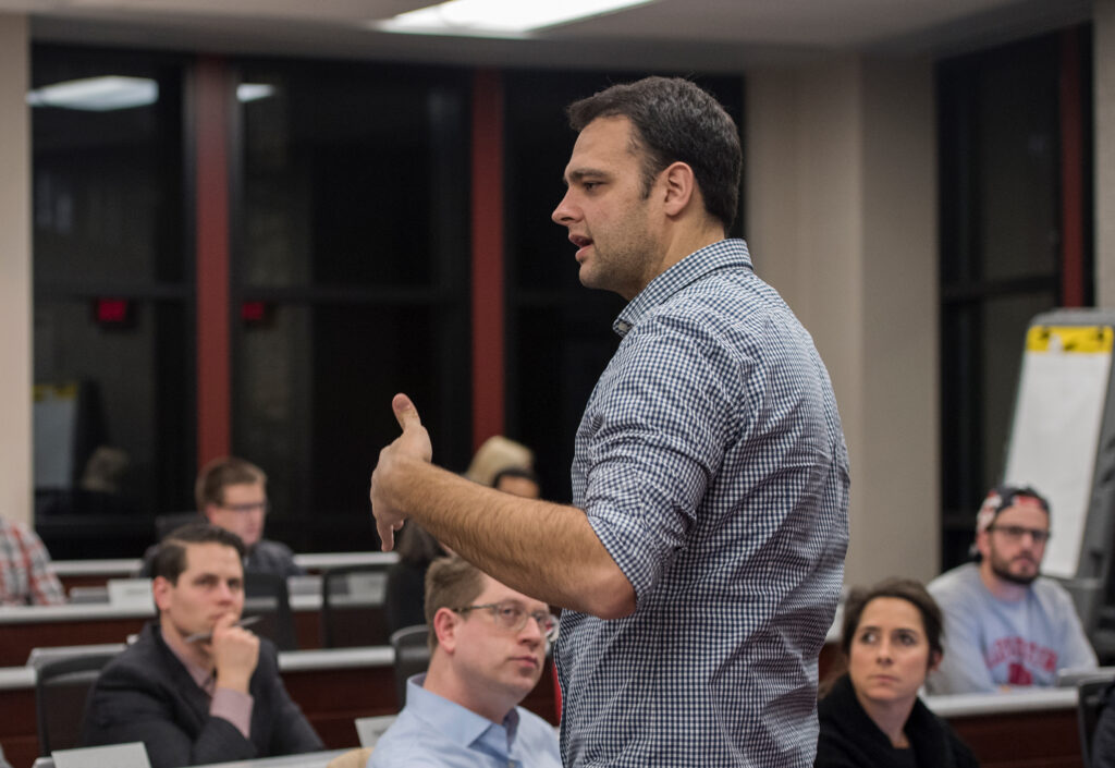 A man talking in front of a class