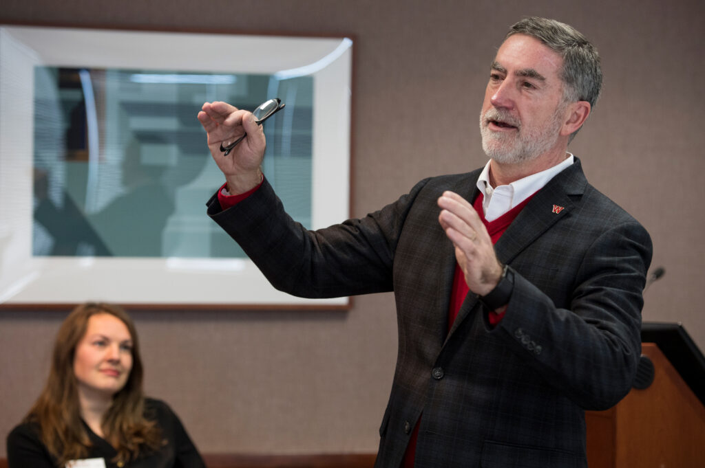 A man talking to people at a conference