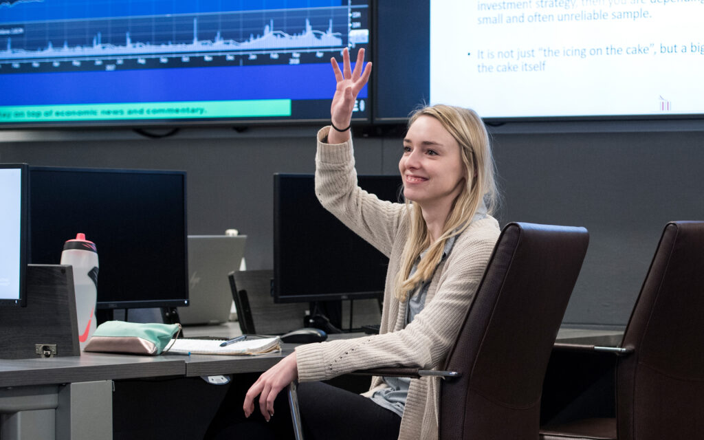 A student raises her hand in class