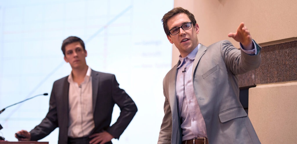 Two men on stage during a presentation