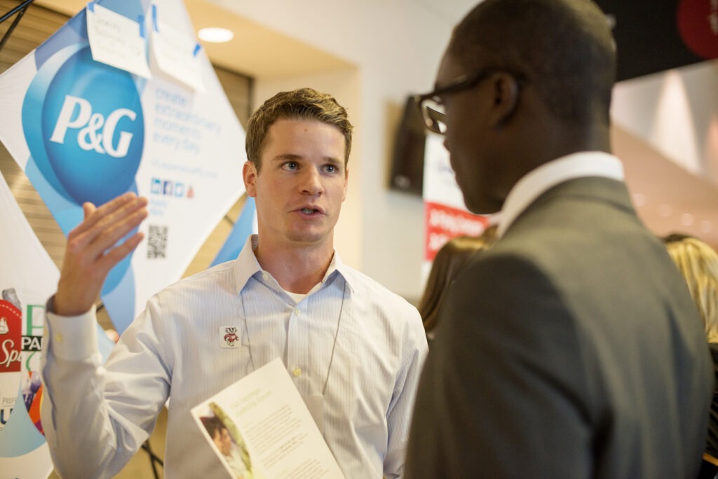 Two men talking at a career fair event