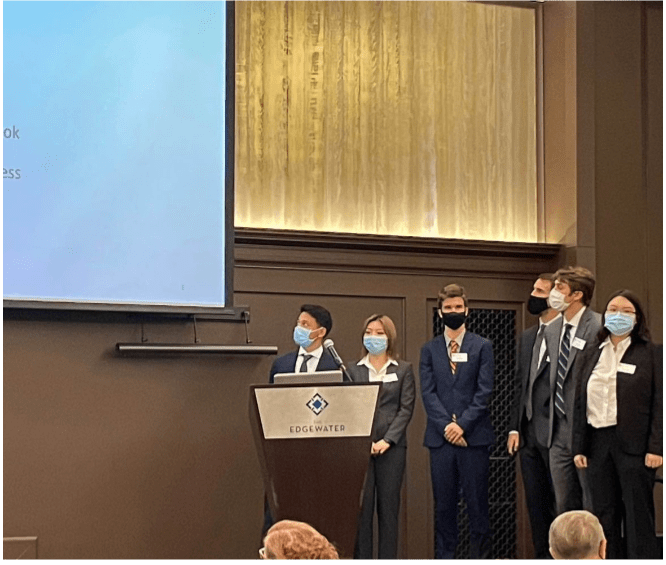 A group of people presenting at a podium