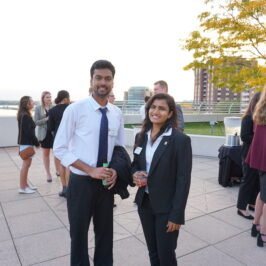 A man and a woman smiling at the camera