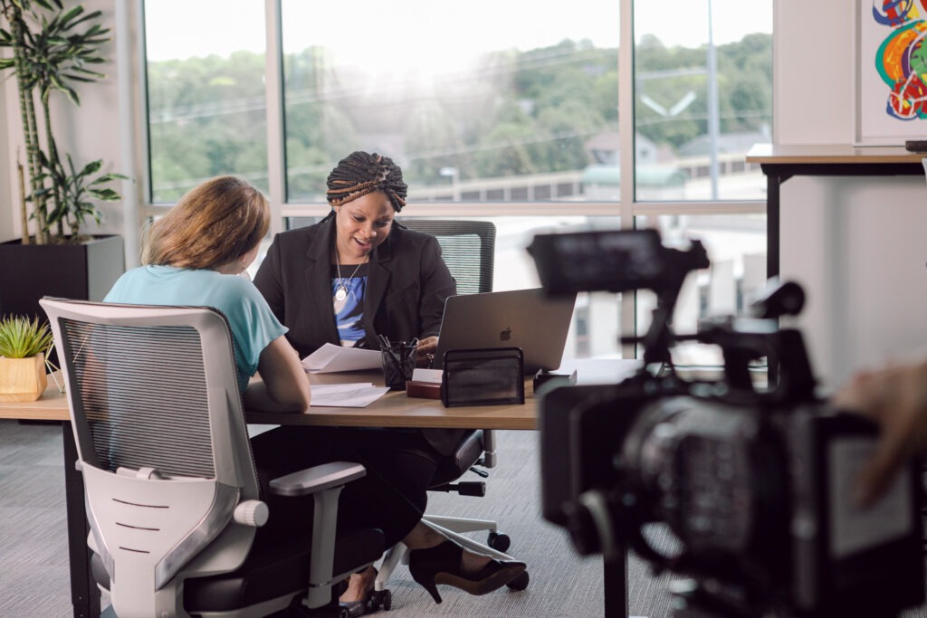 actors play the roles of banker and small business client during a video shoot