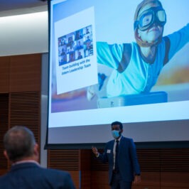 A man presenting a presentation in front of people