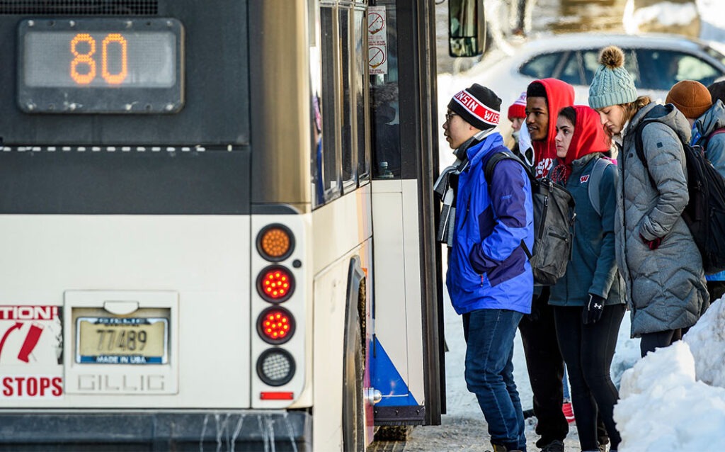 Students getting on the bus in winter