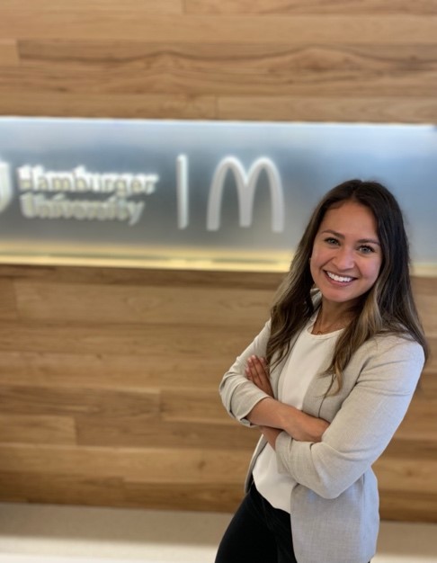The author, Nicole, poses at McDonald's Hamburger University, smiling about her successful summer internship