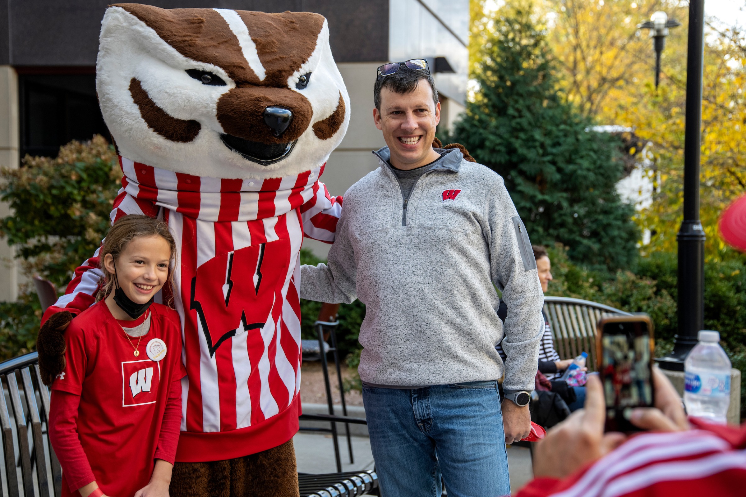 WSB alumn and his daughter pose for a photo with Bucky Badger