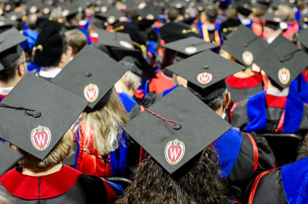 Graduation caps adorned with the iconic W crest are pictured during UW-Madison's spring commencement ceremony at the Kohl Center at the University of Wisconsin-Madison on May 12, 2017. The indoor graduation was attended by approximately 830 doctoral, MFA and medical student degree candidates, plus their guests. (Photo by Bryce Richter / UW-Madison)