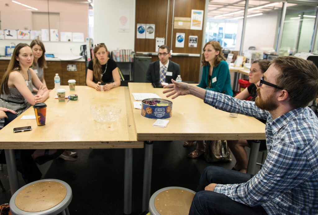 students talking around table