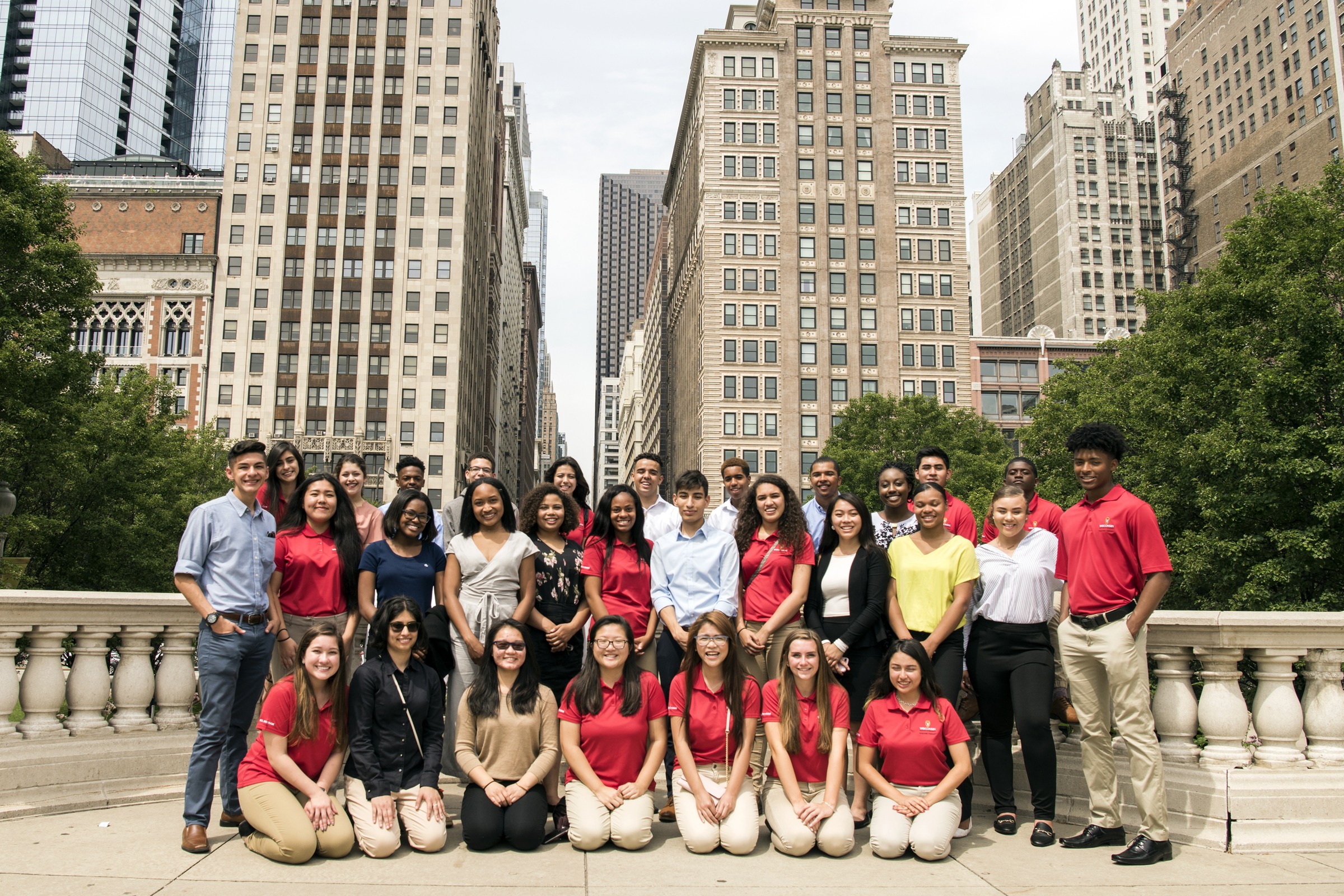 Group of BEL students posing in front of buildings.