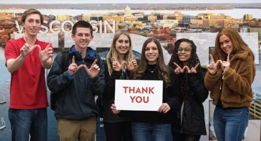 students holding a "Thank You" sign