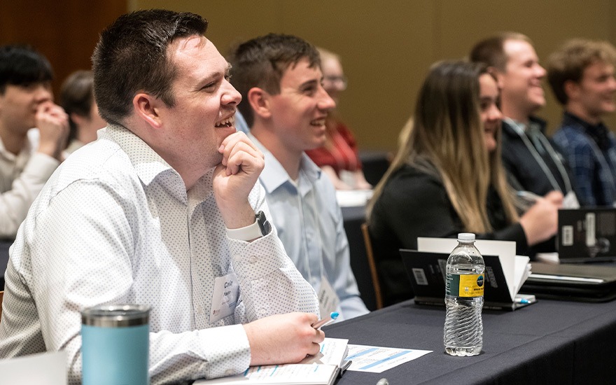 Students react during a panel session of Lambeau business executives