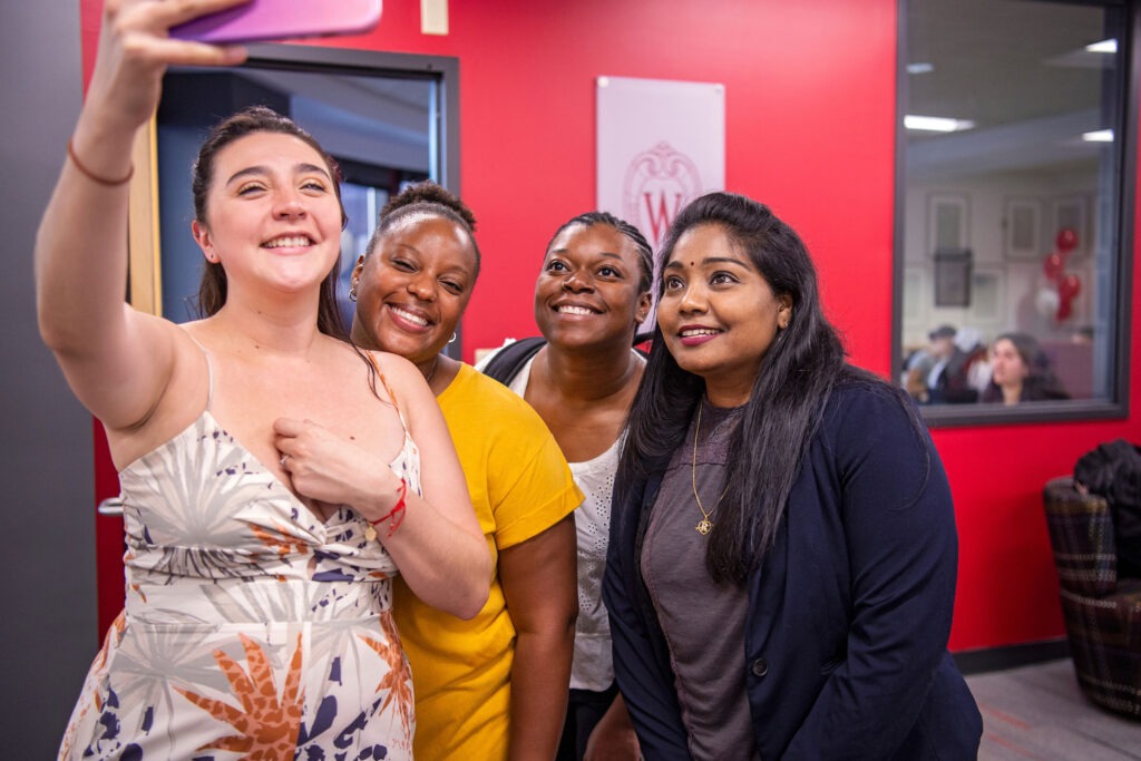 A group of students take a selfie at the Multicultural Center grand opening.