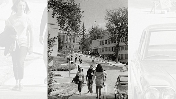 Ingraham Hall, former Commerce building, with students walking on the sidewalk