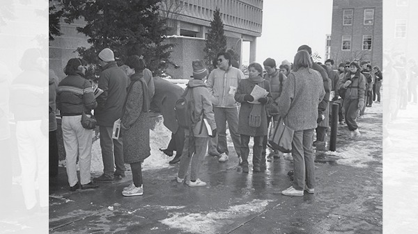 Students standing in a line outside in the snow