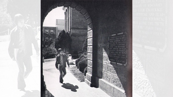 A student walking under an arch at Bascom Hall