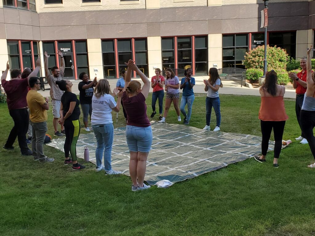 students involved in an outdoor lawn activity
