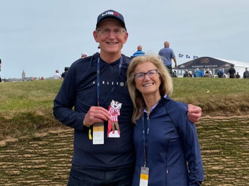 Steve Weber with his wife, holding a paper Bucky Badger