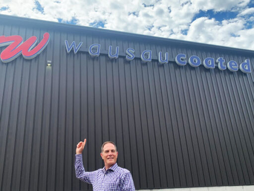 David Rosen standing in front of Wausau Coated Products building