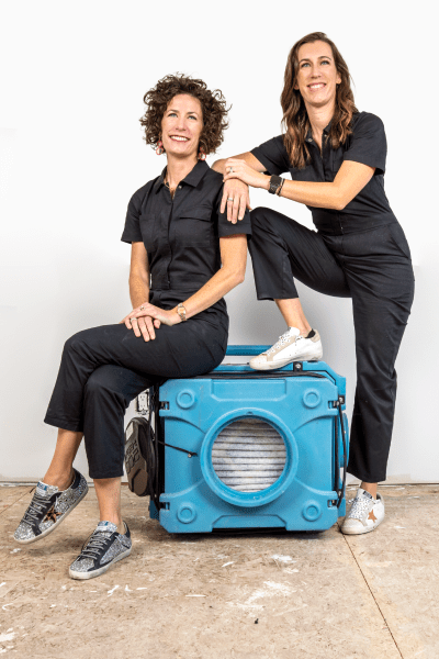 Lindsey and Kirsten posing on equipment