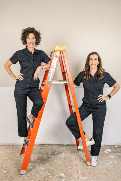 Lindsey and Kirsten Uselding posing on ladder