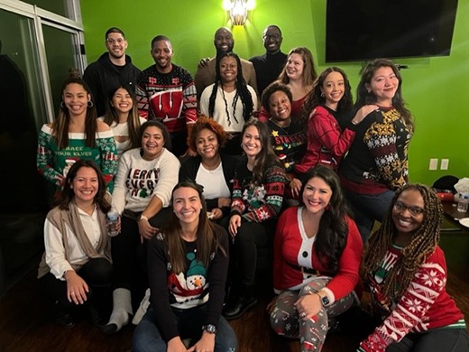 Group of students wearing holiday sweaters