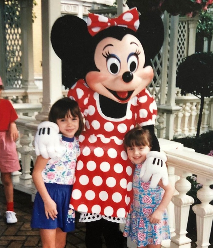 Natalie and her sister posing with Minnie Mouse as young kids