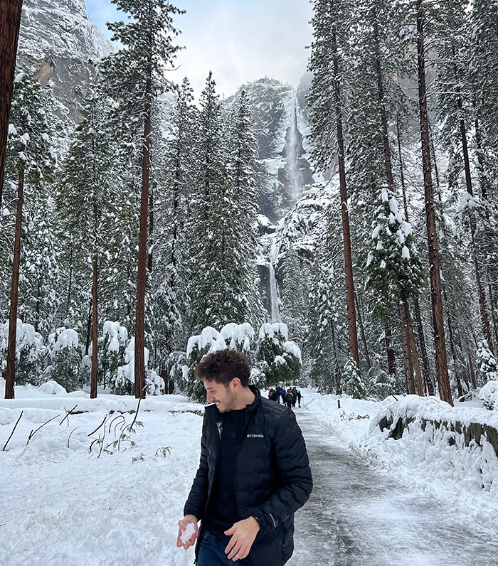 Ebrahem Wahba at Yosemite National Park with snow on the ground and trees.